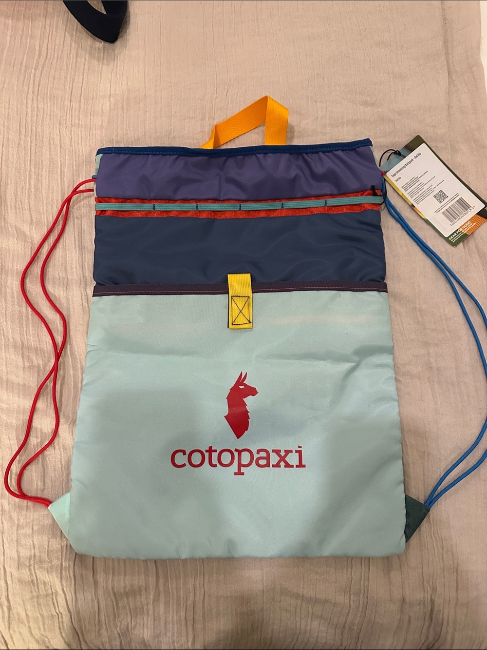 cotopaxi light blue navy purple yellow red drawstring backpack
